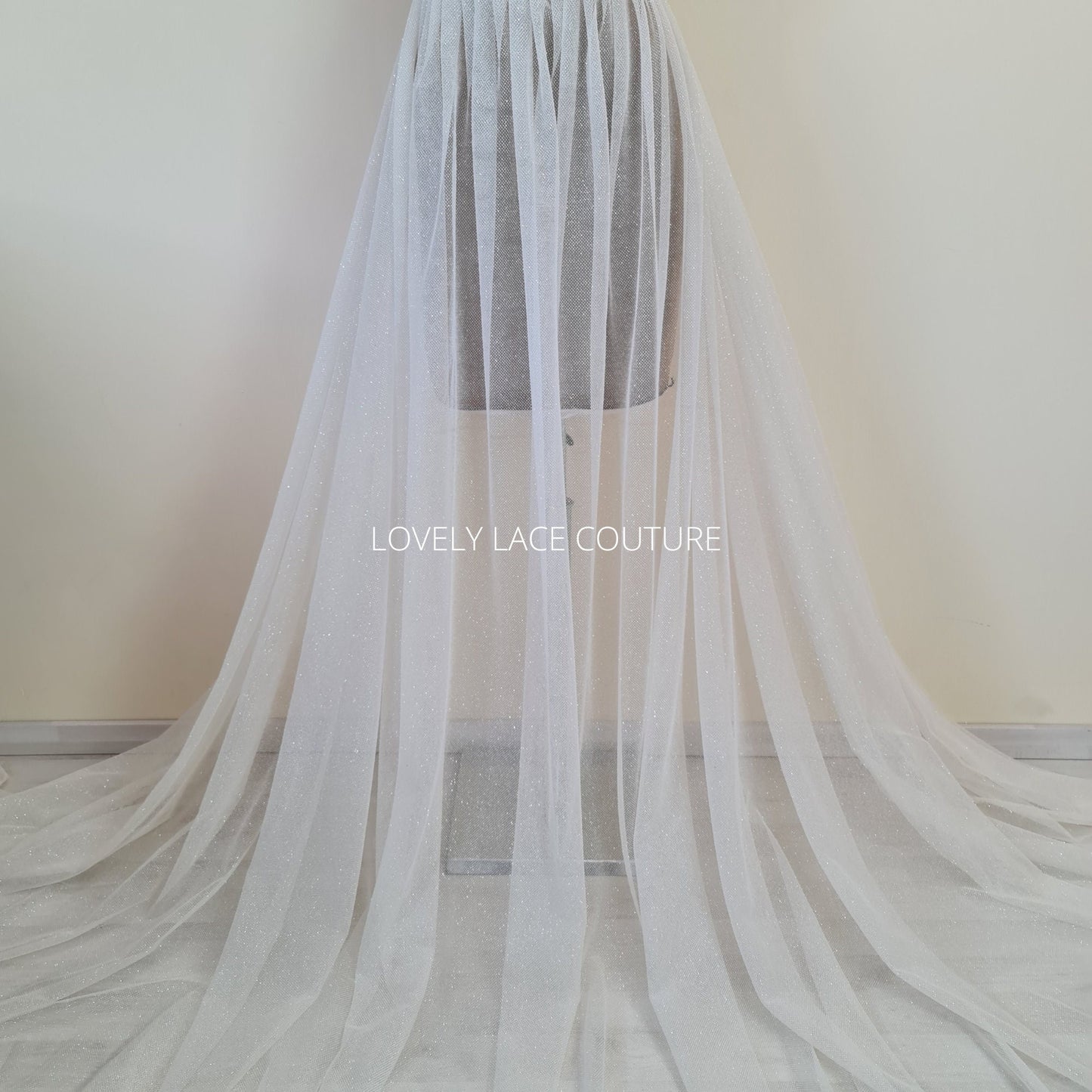 beautiful sparkling glitter tulle fabric in off-white LL-1499 or ivory color LL-1500 for marvelous bridal and wedding dresses or also veils