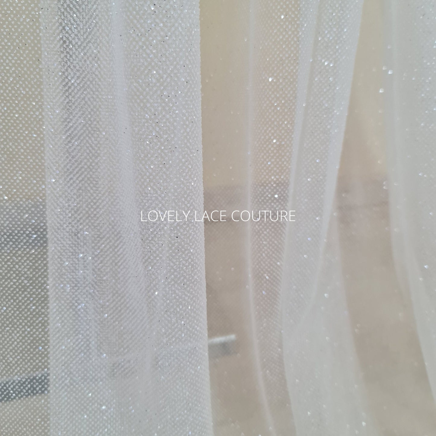 beautiful sparkling glitter tulle fabric in off-white LL-1499 or ivory color LL-1500 for marvelous bridal and wedding dresses or also veils