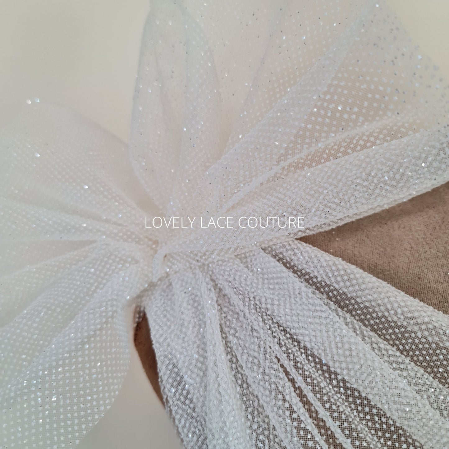 beautiful sparkling glitter tulle fabric in off-white LL-1499 or ivory color LL-1500 for marvelous bridal and wedding dresses or also veils