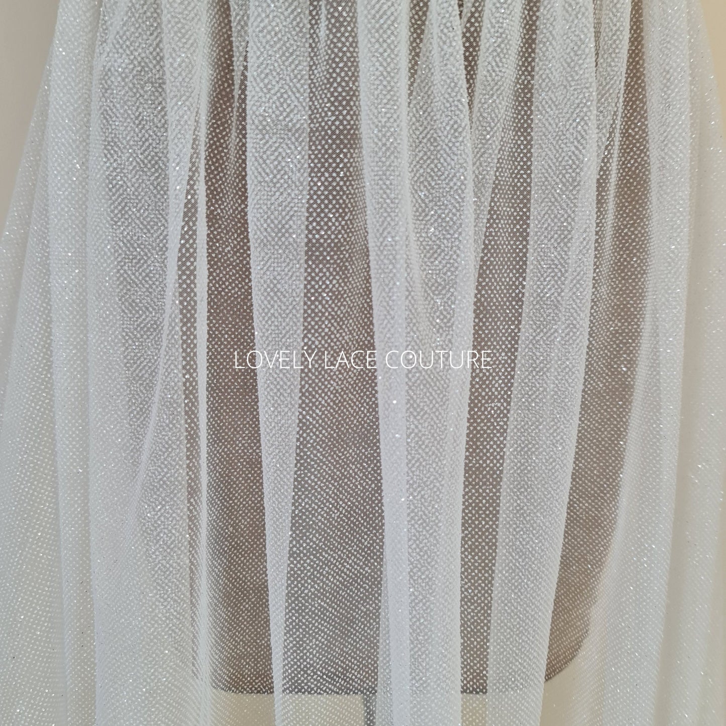 beautiful sparkling glitter tulle fabric in off-white LL-1499 or ivory color LL-1500 for marvelous bridal and wedding dresses or also veils