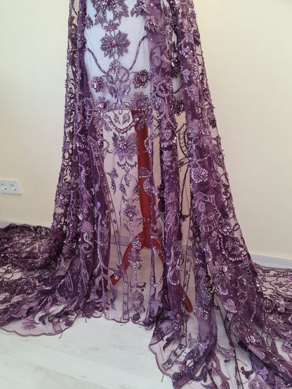purple lace fabric draped on dressform from lower part