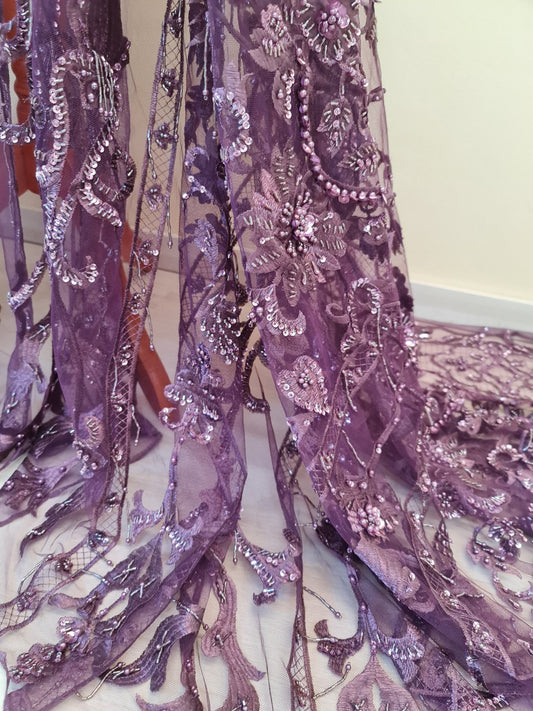 close up of beaded lace fabric in purple color