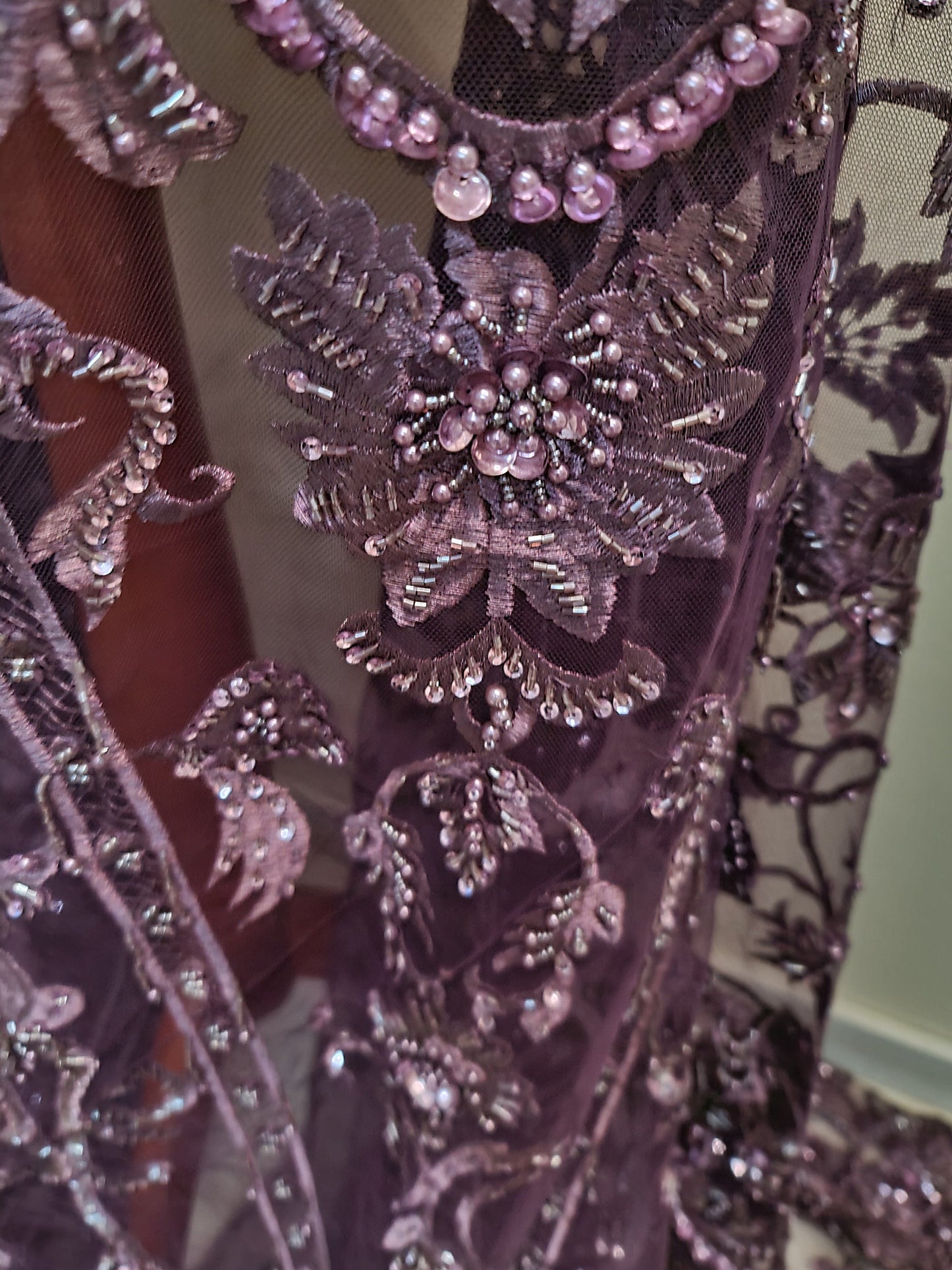 close up from purple fabric with beads and sequins