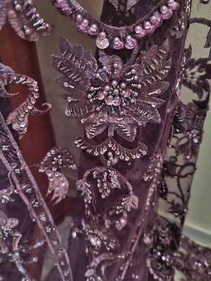 close up from purple fabric with beads and sequins