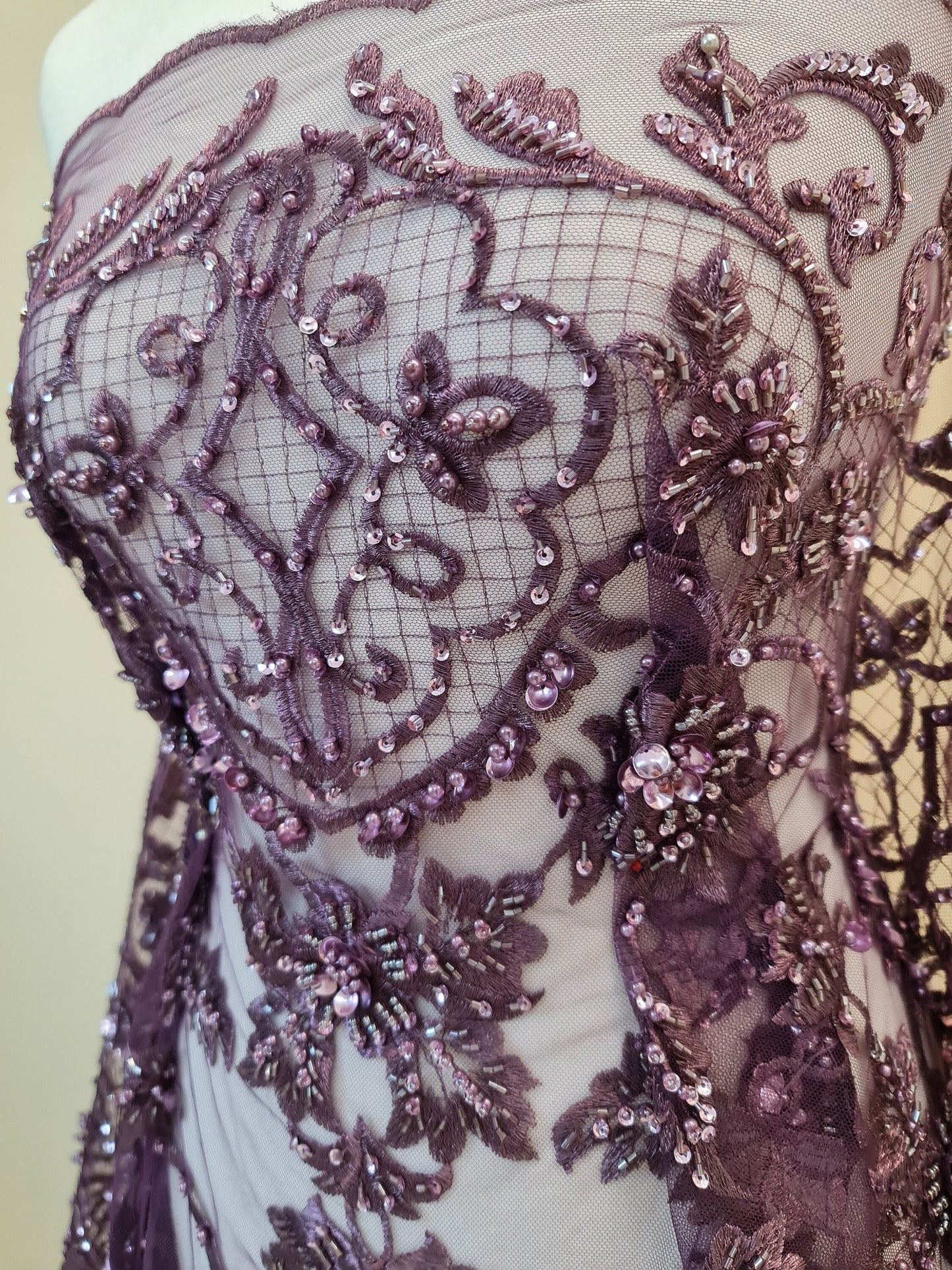 close up, lace fabric in purple color on dressform from upper part