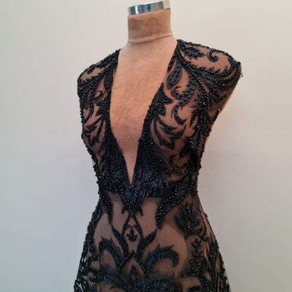 ornamental black lace draped on dress form, upper part