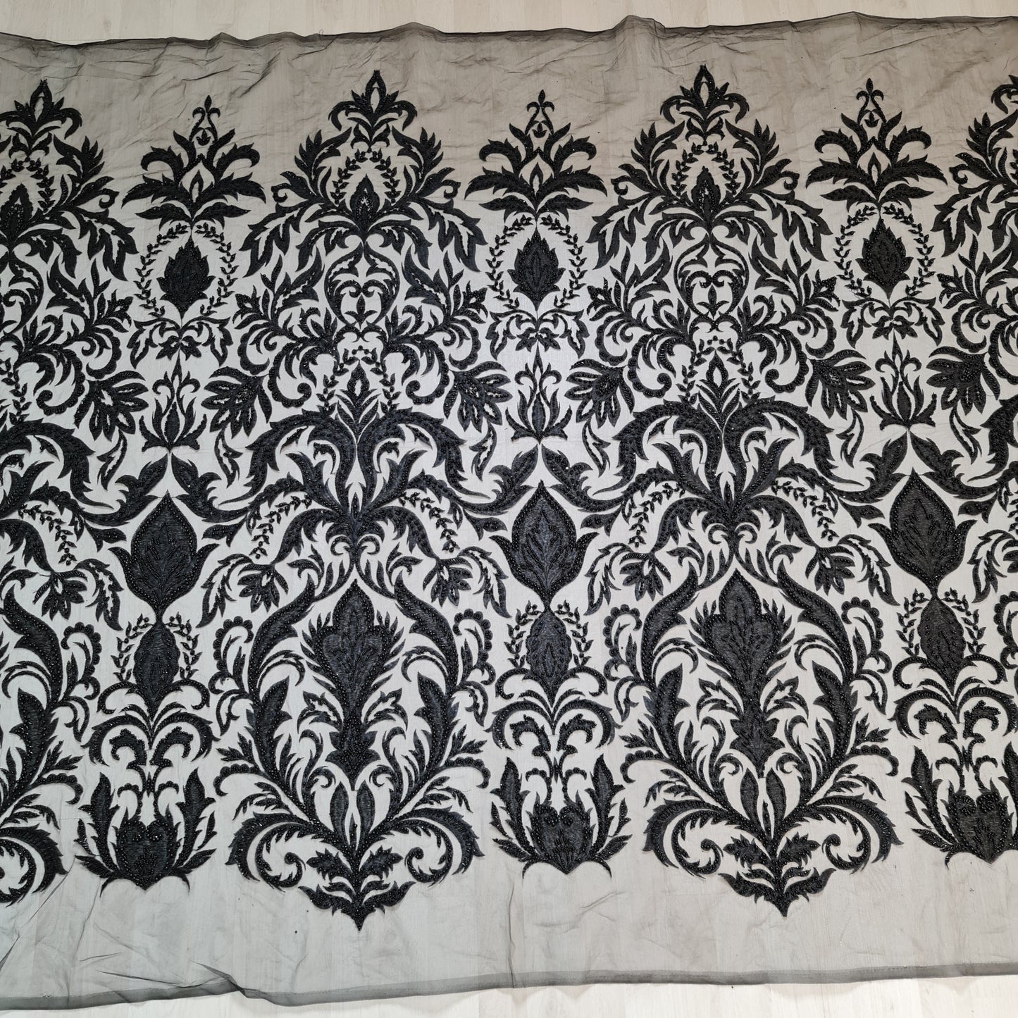 full pattern of black lace fabric with ornamental design