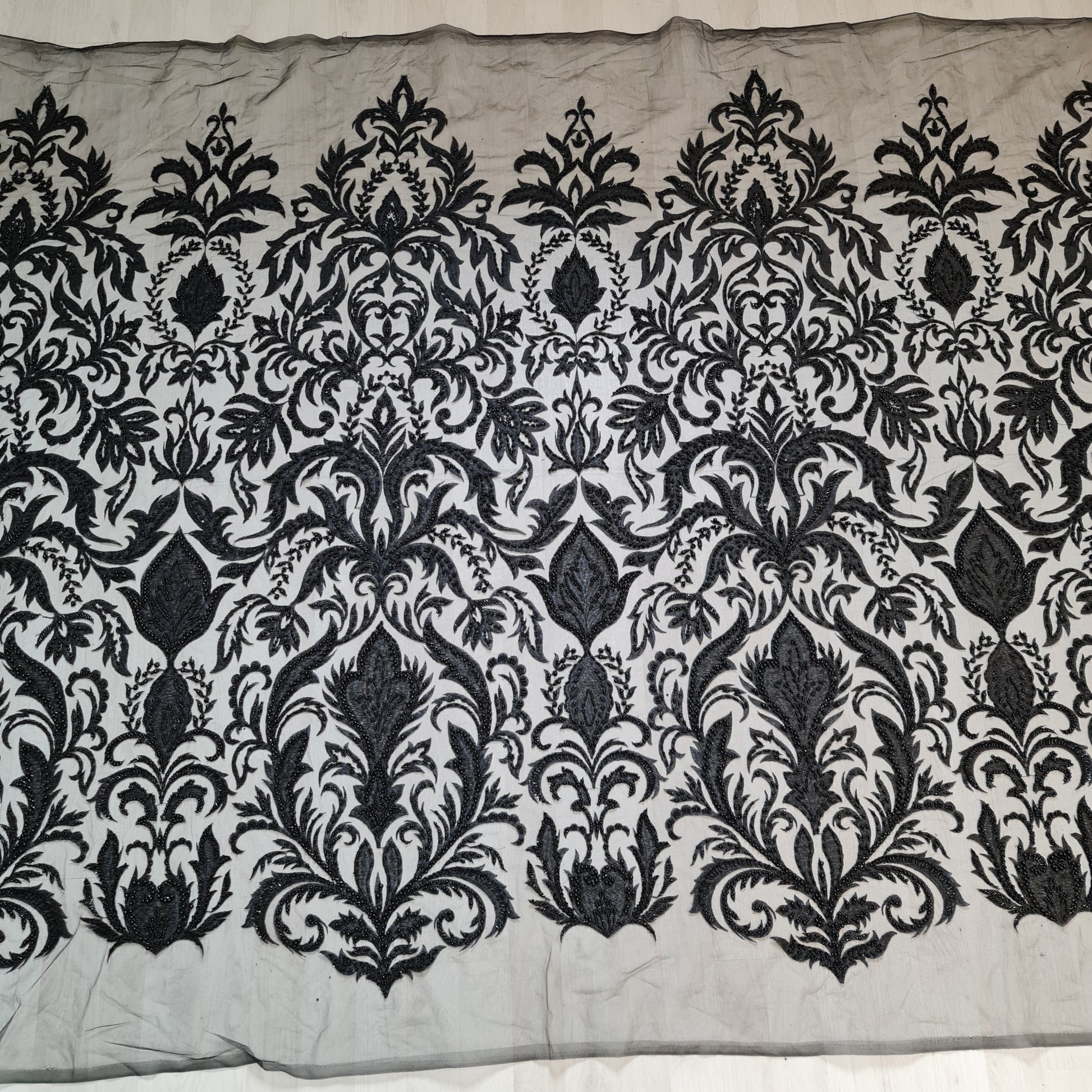 full pattern of black lace fabric with ornamental design