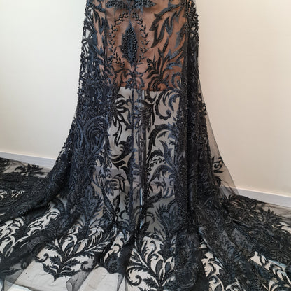 black lace fabric on dressform as a skirt shown, lower part