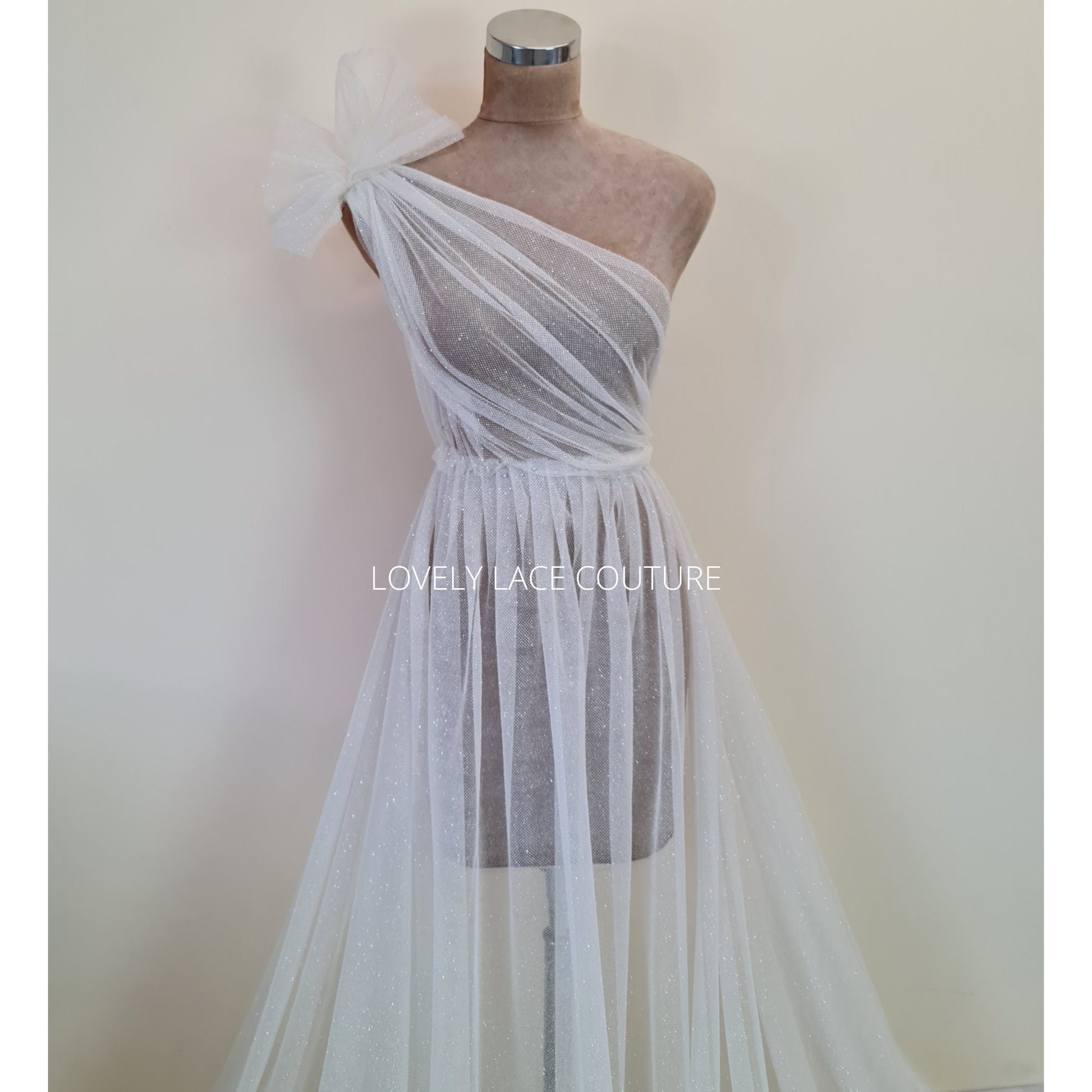 beautiful sparkling glitter tulle fabric in off-white LL-1499 or ivory color LL-1500 for marvelous bridal and wedding dresses or also veils