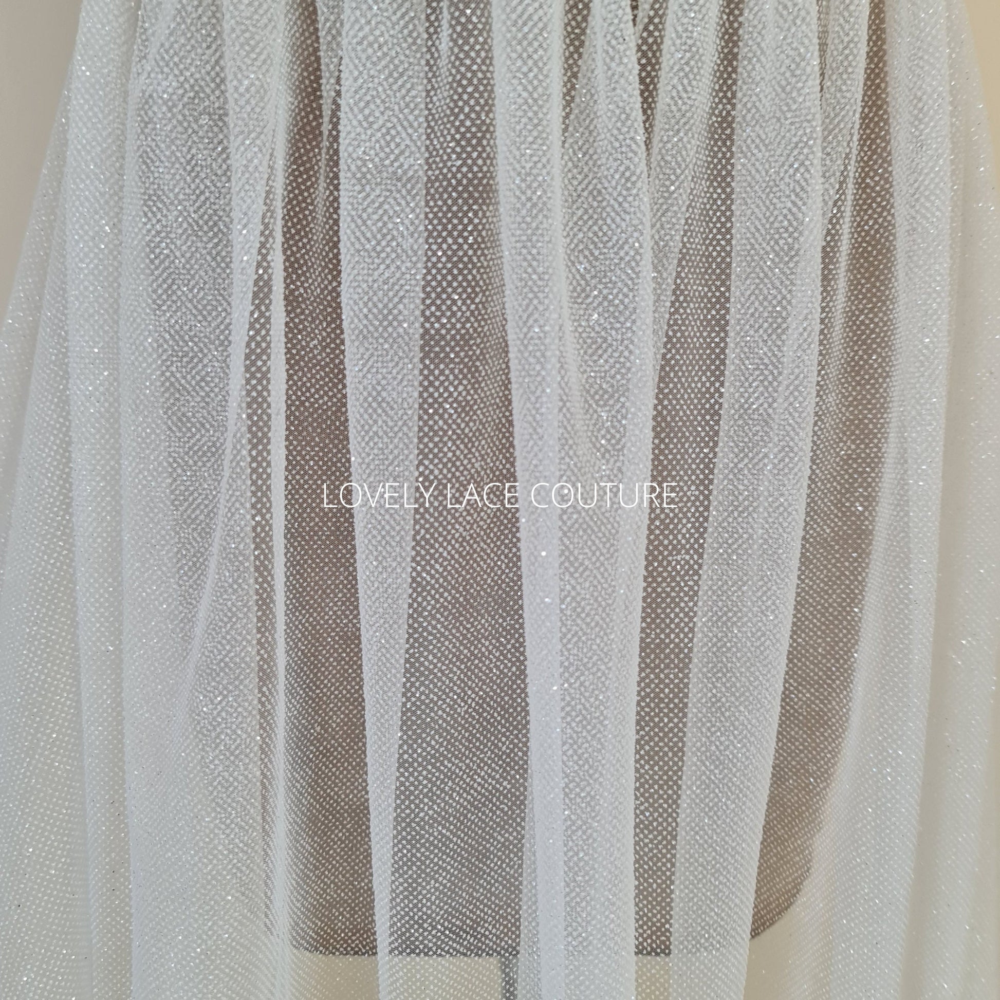 beautiful sparkling glitter tulle fabric in off-white LL-1499 or ivory color LL-1500 for marvelous bridal and wedding dresses or also veils