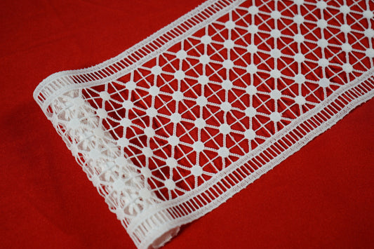 Guipure ribbon lace fabric in white color.