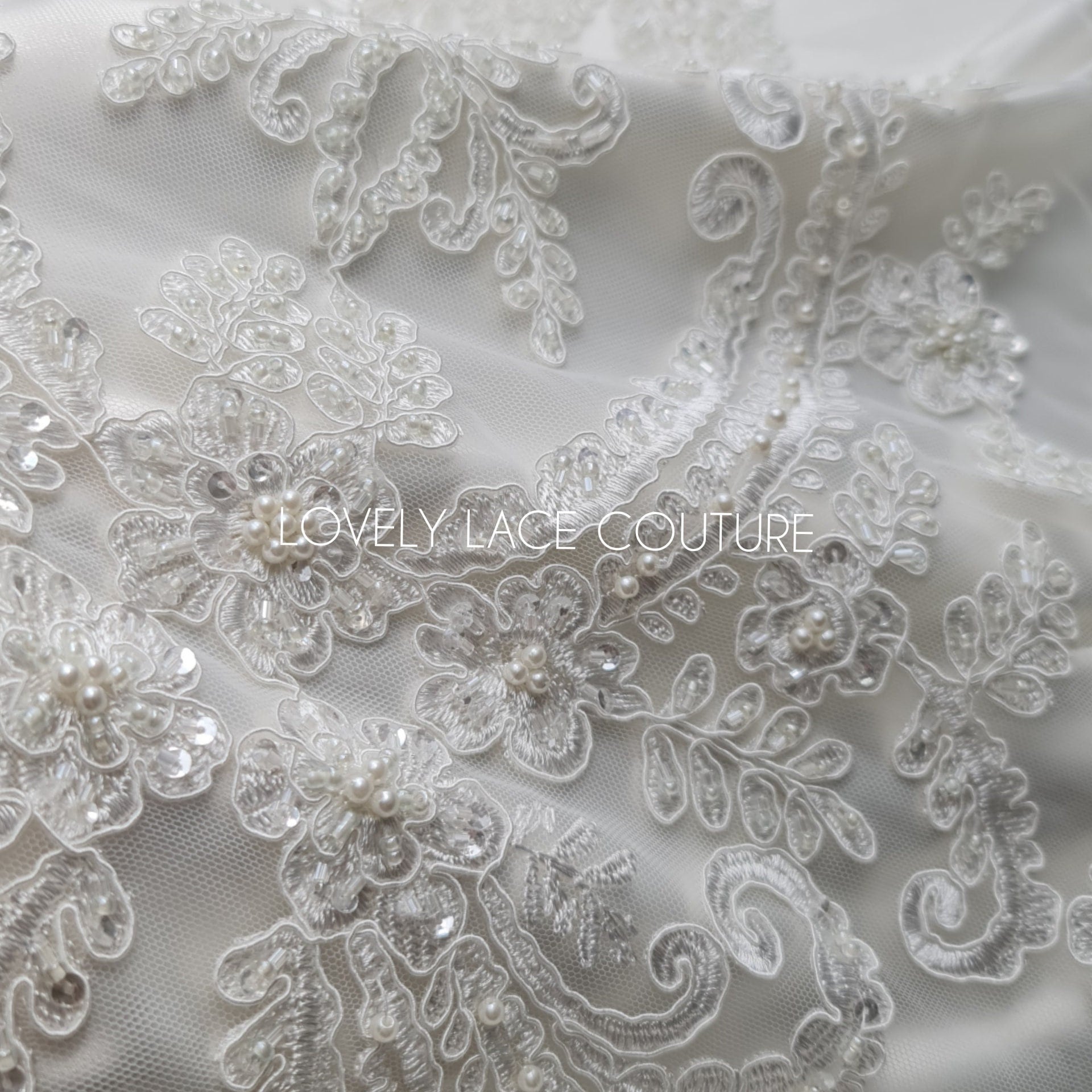 lace fabric with ornamental pattern in off-white color