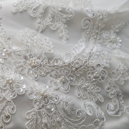 lace fabric with ornamental pattern in off-white color