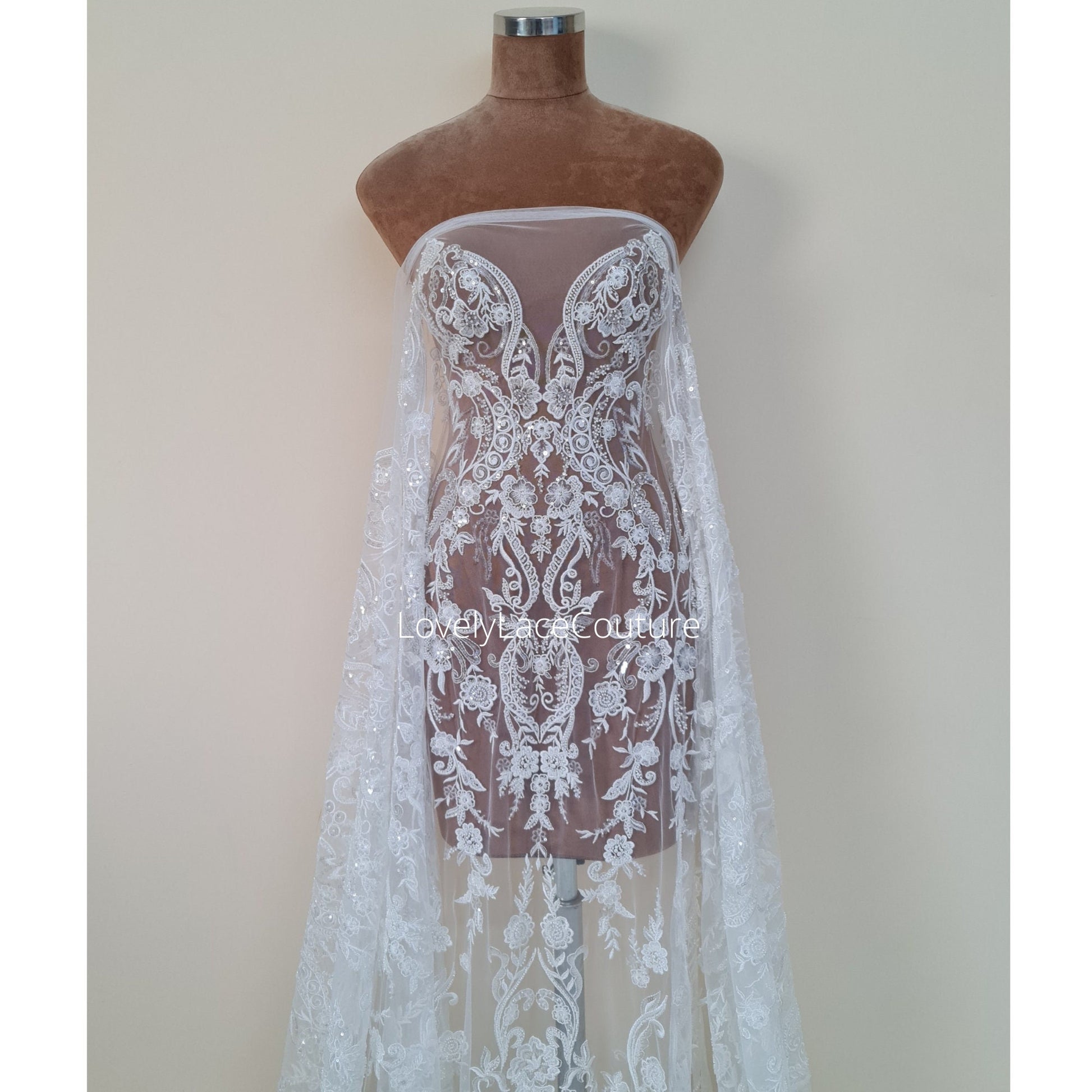 lace fabric with floal ornaments in off-white color for bridal wear
